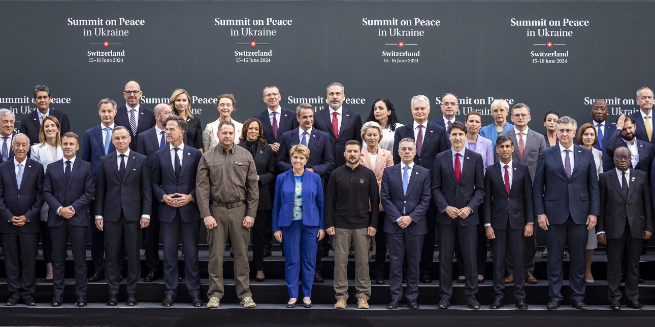Group photo of world leaders in front of a backdrop saying Summit on Peace in Ukraine
